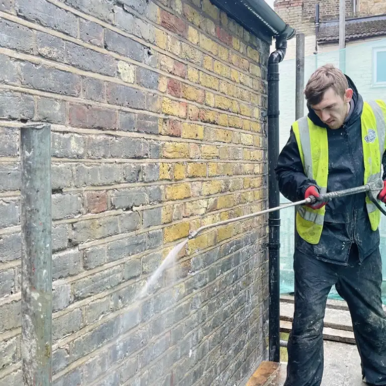 Brick wall steam cleaning showing clean results